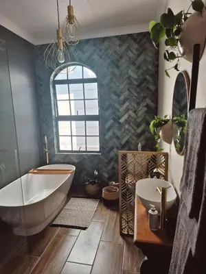 a bathroom with a tub and a sink at Hibiscus at Bougainvillea House in Pretoria