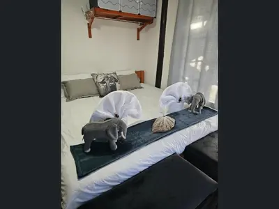 a bed with two elephant figurines on top of it at Kruger Boutique Backpackers in Marloth Park