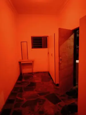 a room with orange walls and a hallway with a door at Madiva Nelspruit Guest House in Nelspruit