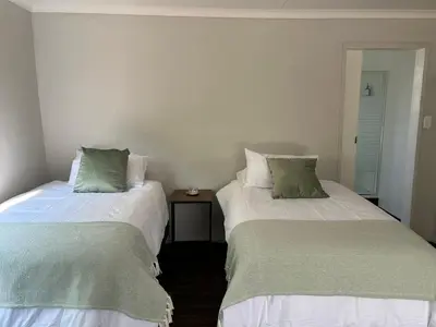 two beds sitting next to each other in a room at One Eight Seven on Moepel in Malelane