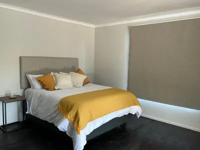 a bedroom with a bed and a window at One Eight Seven on Moepel in Malelane