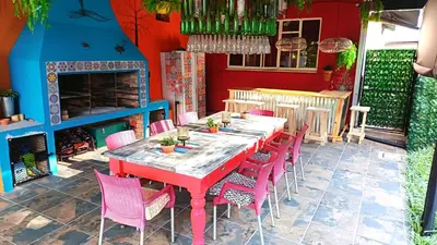 a red table and chairs on a patio at 34th on Pierneef in Pretoria