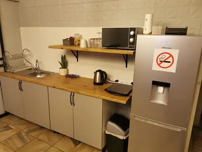 a kitchen with a refrigerator with a no smoking sign on it at 34th on Pierneef in Pretoria
