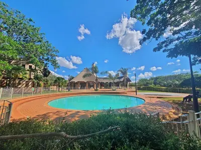 a swimming pool in a park with a gazebo at Mooikloof Ridge Hide Out in Pretoria