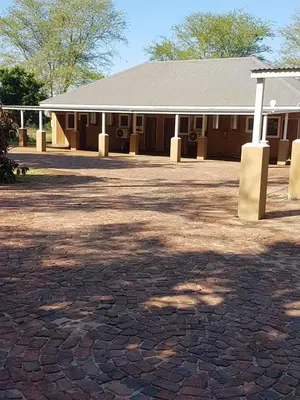 a building with a brick driveway in front of it at Old Mine Guesthouse in Musina