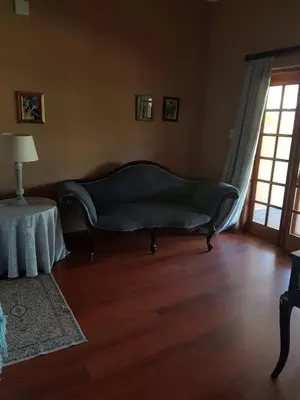 a living room with a couch and a table at Old Mine Guesthouse in Musina