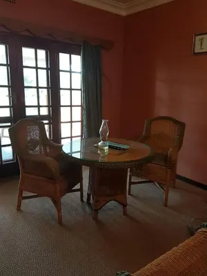 a living room with a table and two chairs at Old Mine Guesthouse in Musina