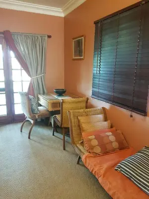 a living room with a table and a couch at Old Mine Guesthouse in Musina