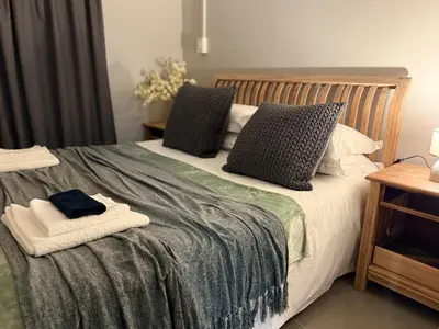 a bedroom with a bed with towels on it at 1170 on Kuskoraal - Apartment, Pretoria in Pretoria