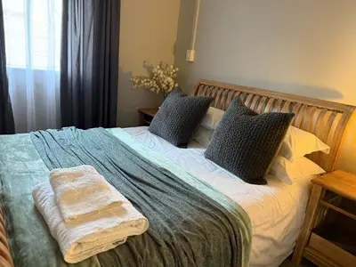 a bed with two pillows and a blanket on it at 1170 on Kuskoraal - Apartment, Pretoria in Pretoria