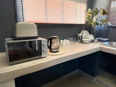 a microwave sitting on a counter in a kitchen at 1170 on Kuskoraal - Apartment, Pretoria in Pretoria