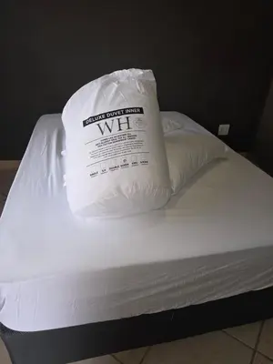 a white pillow sitting on top of a bed at The Good Samaritan 2 in Witbank