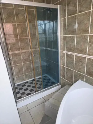 a shower with a glass door in a bathroom at The Good Samaritan 2 in Witbank