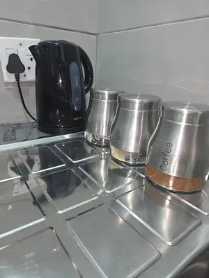 a stove top with three coffee cups on it at The Good Samaritan 2 in Witbank