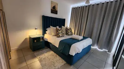 a bedroom with a bed with pillows on it at White House At The Blyde Crystal Lagoon in Pretoria