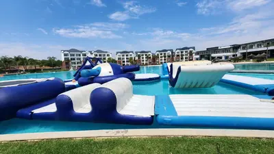 a water slide in a pool at a resort at White House At The Blyde Crystal Lagoon in Pretoria