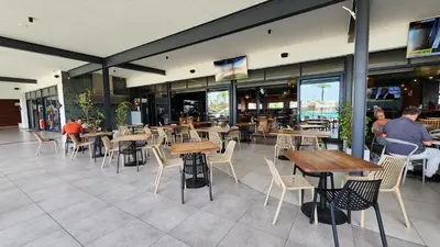 a restaurant with tables and chairs and people sitting in it at White House At The Blyde Crystal Lagoon in Pretoria