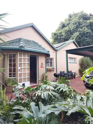 a house with a lot of plants in front of it at Lily's Inn in Centurion