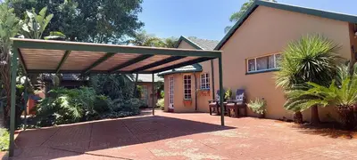 a pergola over a walkway in front of a house at Lily's Inn in Centurion