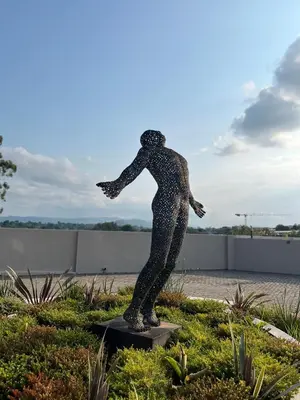 a statue of a person is standing in a garden at The Legacy Hotel and Spa in Tzaneen