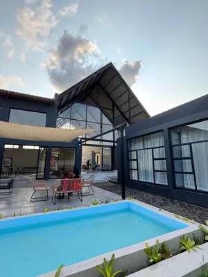 a house with a swimming pool in front of it at The Legacy Hotel and Spa in Tzaneen
