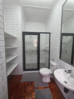 a bathroom with a shower and a toilet and a sink at 153 A Marshall in Polokwane