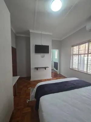 a bedroom with a bed and a flat screen tv at 153 A Marshall in Polokwane