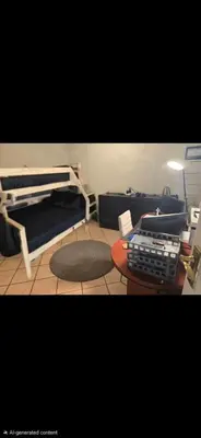 a room with a bed and a desk with a keyboard at Garys Place -Work-ready, family-friendly, and braai-happy in Centurion
