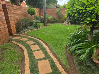 a garden with a stone path in the grass at Garys Place -Work-ready, family-friendly, and braai-happy in Centurion