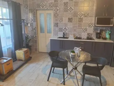 a kitchen with a table and chairs and a counter at Infinity Piece at Centurion in Centurion