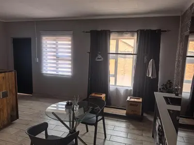 a living room with a glass table and chairs at Infinity Piece at Centurion in Centurion