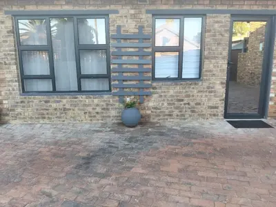 a vase sitting in front of a brick building at Infinity Piece at Centurion in Centurion
