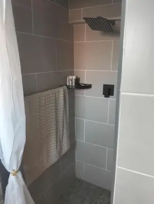a bathroom with a shower with a towel at Infinity Piece at Centurion in Centurion