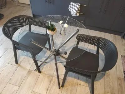 a glass table with two chairs and a plant on it at Infinity Piece at Centurion in Centurion