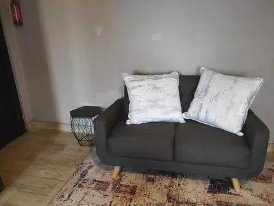 a gray couch with two pillows on it in a room at Infinity Piece at Centurion in Centurion