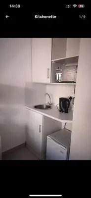 a small white kitchen with a sink and a microwave at Soteria House in Kempton Park