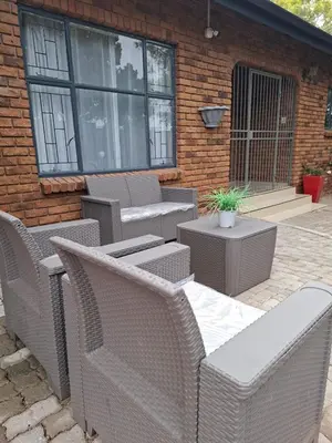 a group of wicker chairs and tables on a patio at Roots of Grace in Polokwane