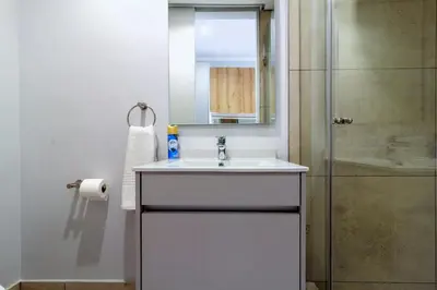 a bathroom with a sink and a shower at Ellipse Waterfall 4212 in Midrand