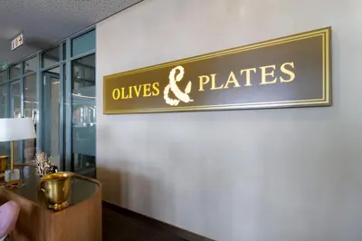 a sign that reads olives and plates on a wall at Ellipse Waterfall 4212 in Midrand