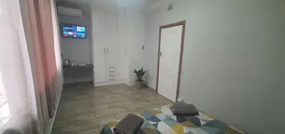 a hallway with a mirror and a room with a door at 329 on 30th Avenue Villieria Drian in Pretoria