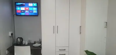 two white cabinets with a tv on top of them at 329 on 30th Avenue Villieria Drian in Pretoria