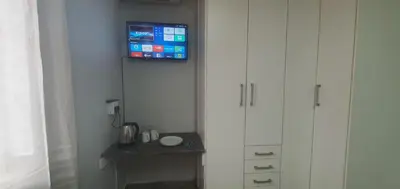 a corner of a room with a tv on a wall at 329 on 30th Avenue Villieria Drian in Pretoria