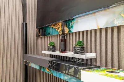a room with two shelves with plants on a wall at 2 Bed 2 Bath Apartment, Ellipse, Waterfall in Midrand