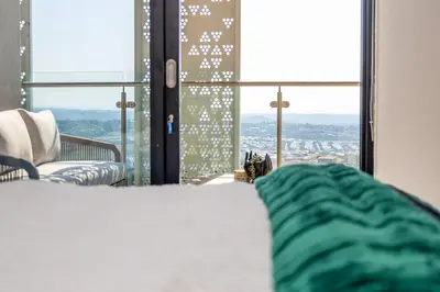 a room with a bed and a window with a view at 2 Bed 2 Bath Apartment, Ellipse, Waterfall in Midrand
