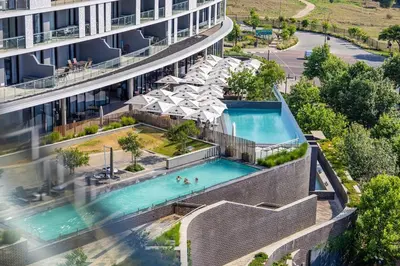 an aerial view of a building with a swimming pool at 2 Bed 2 Bath Apartment, Ellipse, Waterfall in Midrand