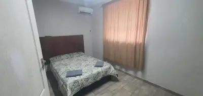a small bedroom with a bed and a window at 329 on 30th Avenue Villieria Justin in Pretoria