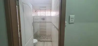a white bathroom with a toilet and a window at 329 on 30th Avenue Villieria Justin in Pretoria
