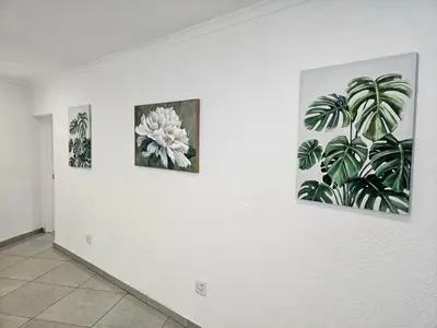 three paintings on a wall in a room at The M GuestHouse in Kempton Park