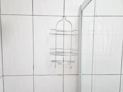 a shower with four towel racks in a bathroom at The M GuestHouse in Kempton Park