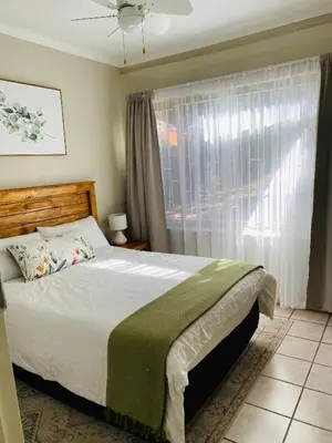 a bedroom with a large bed and a window at Springbok 47 in Polokwane